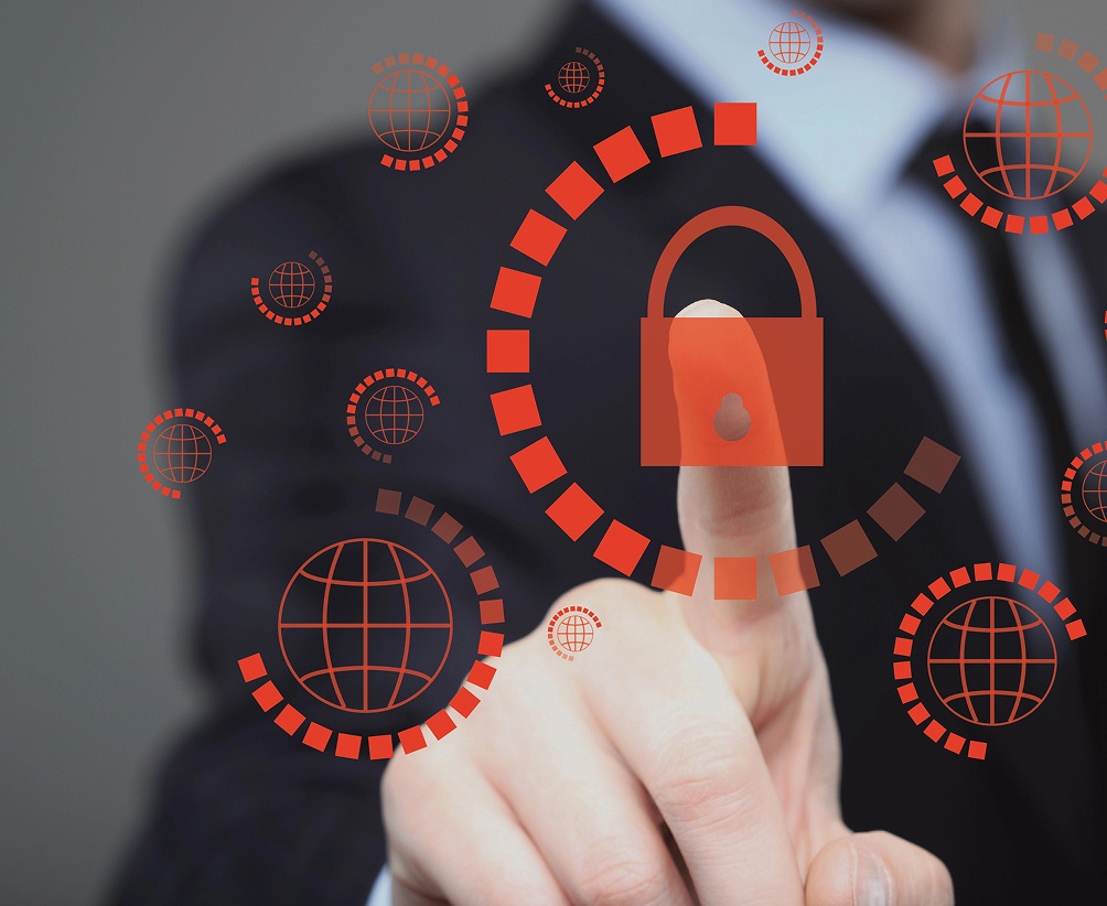 Businessman pressing a padlock icon on a virtual screen, symbolizing security and data protection.