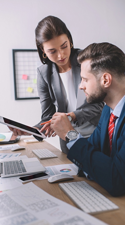 Business professionals collaborating around a conference table in a modern office setting.