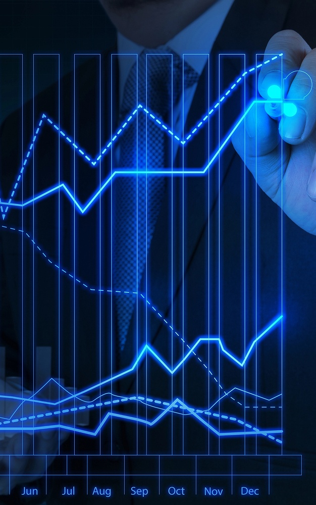Businessman sketching graphs on a digital screen, illustrating data trends and analysis in a professional setting.